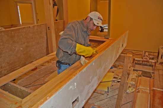 Stripping the fireplace mantle on the first floor.